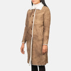 Women's Alina long brown shearling leather coat with fitted sleeves and front center slit, angled 