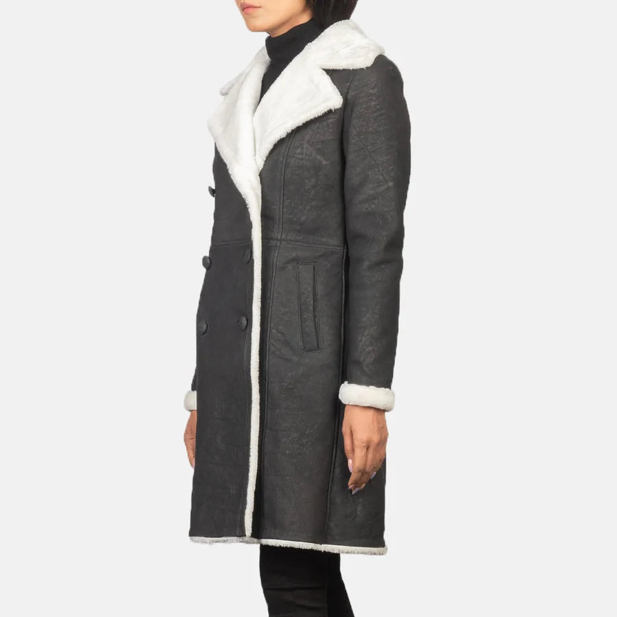 Women's Amie black double-breasted shearling coat with dark buttons and white fur facing, angled