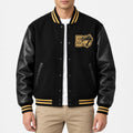 Men’s black wool blend varsity jacket with leather sleeves, gold striped rib collar and cuffs