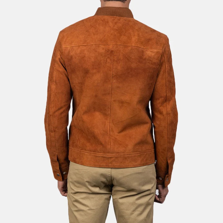 Back view of a man wearing a tan brown suede bomber jacket.