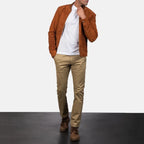Full-body front view of a model wearing a brown suede leather jacket with beige trousers.