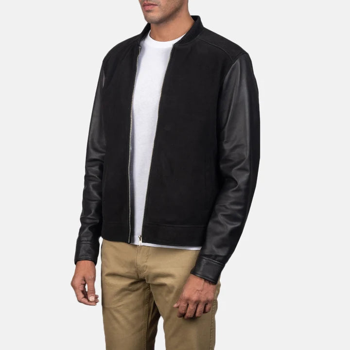 Three-quarter side angle view of a man wearing a black hybrid leather bomber jacket.