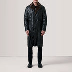 Men's Cai long black leather shearling coat worn full length with button closure, full length