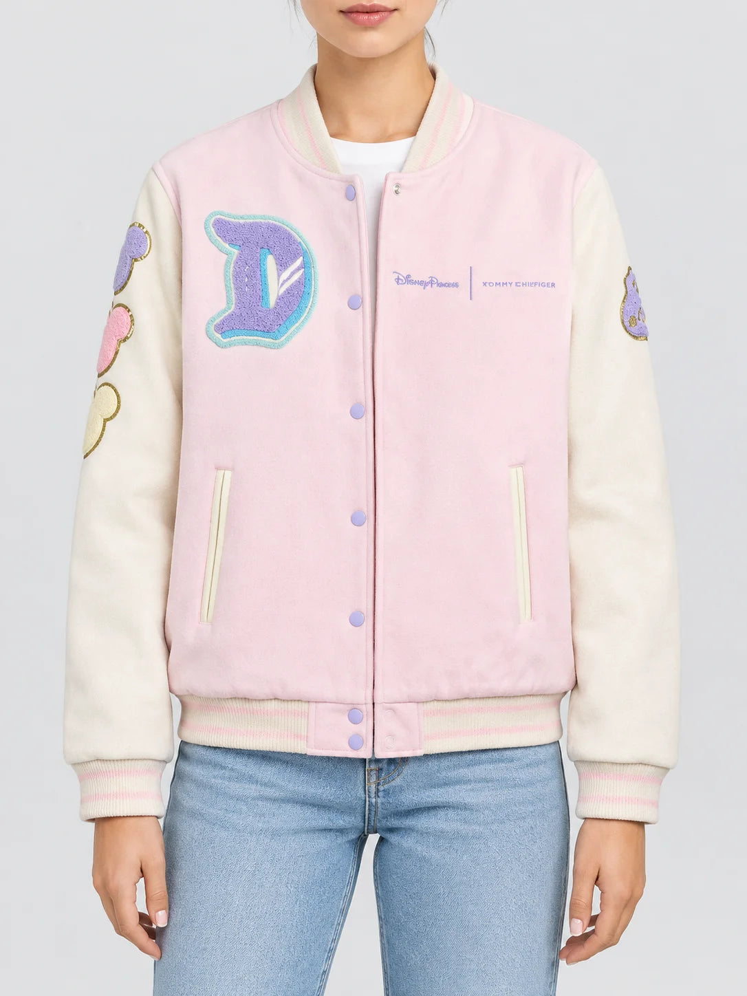 Women’s pink wool varsity jacket with cream sleeves, chenille patches and snap button front