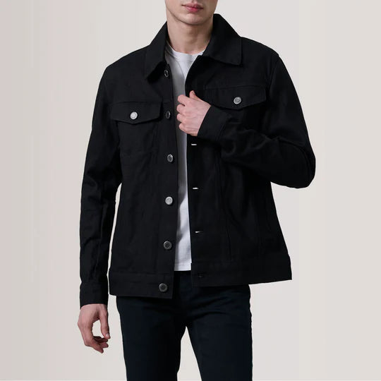 Front view of a man wearing Conard Black Denim Trucker Jacket with hands in pockets