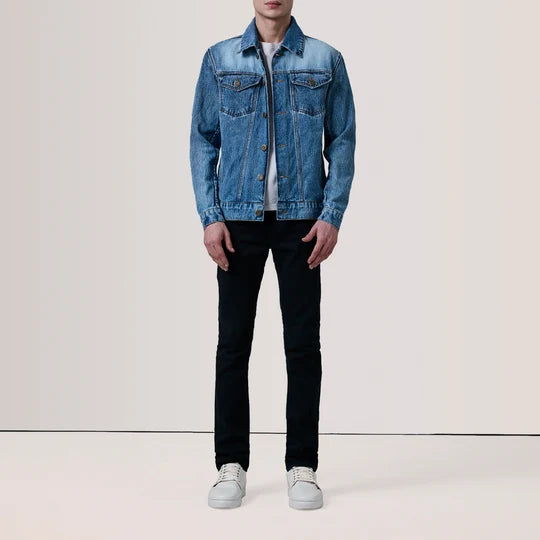 Full body view of men's ice blue denim jacket paired with black trousers