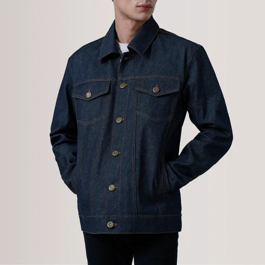Front view of a man wearing Conard Indigo Blue Denim Trucker Jacket with hands in pockets