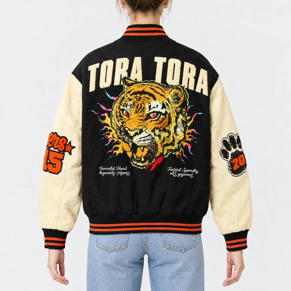Women’s black wool varsity jacket with cream leather sleeves and orange striped rib collar, cuffs and hem