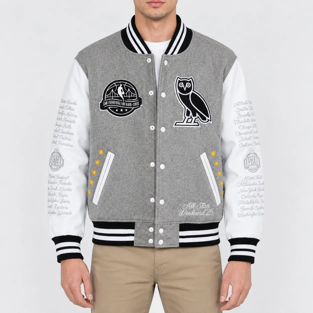 Men’s grey wool varsity jacket with white leather sleeves, striped rib trim, snap front and embroidered patches