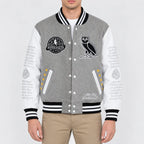 Men’s grey wool varsity jacket with white leather sleeves, striped rib trim, snap front and embroidered patches