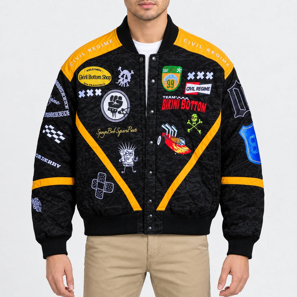 Men’s black twill racing bomber jacket with yellow panels, ribbed collar, snap-button front and embroidered patches