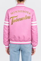 Women’s pink satin full-snap varsity jacket with gold script lettering across the back and white sleeve stripes