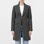 Women’s black and white tweed wool coat with notched lapel collar, front zipper, flap pockets and sleeve zip pocket